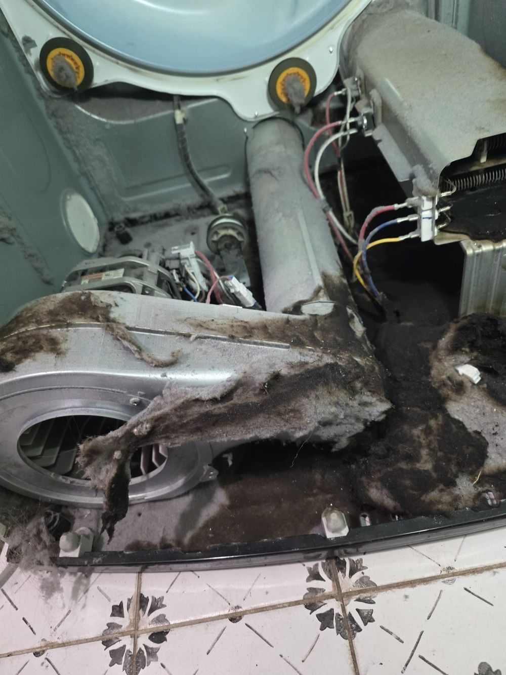 Dryer interior with heavy lint buildup near the heating element