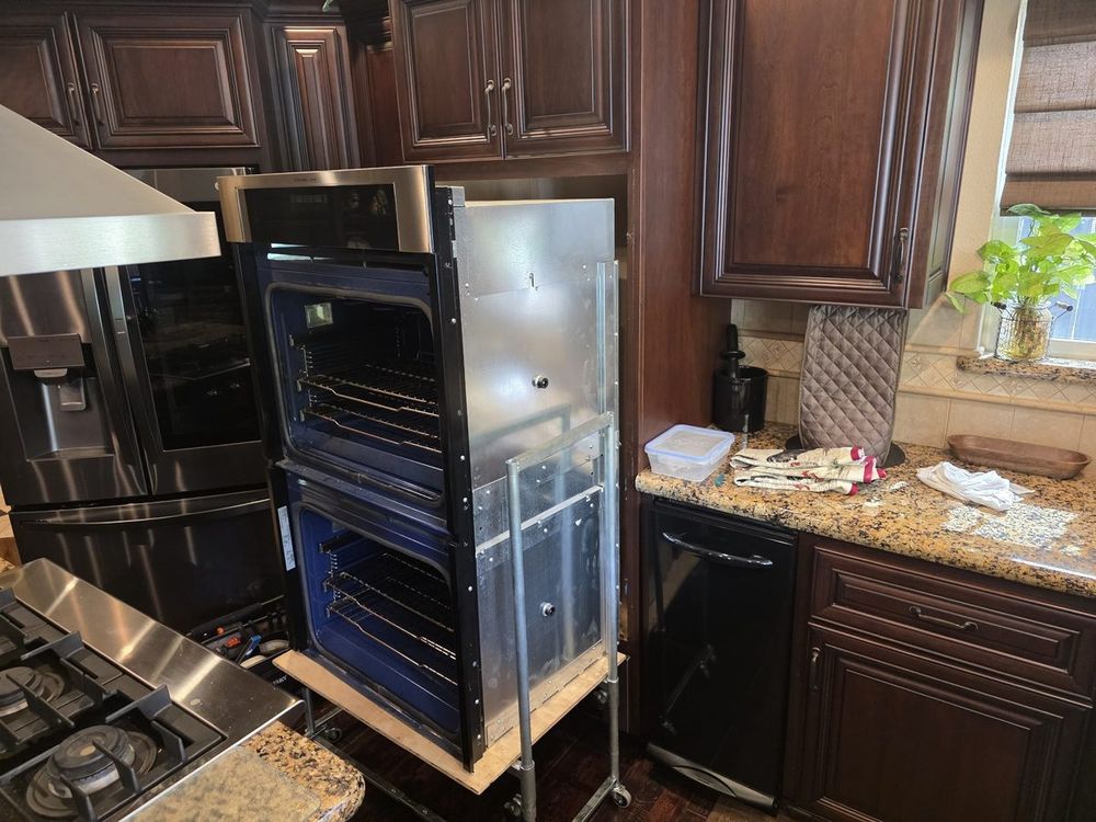 Double wall oven on a lift during built-in oven service