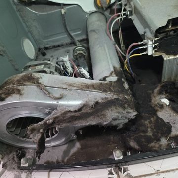 Dryer interior with lint buildup near the heating element